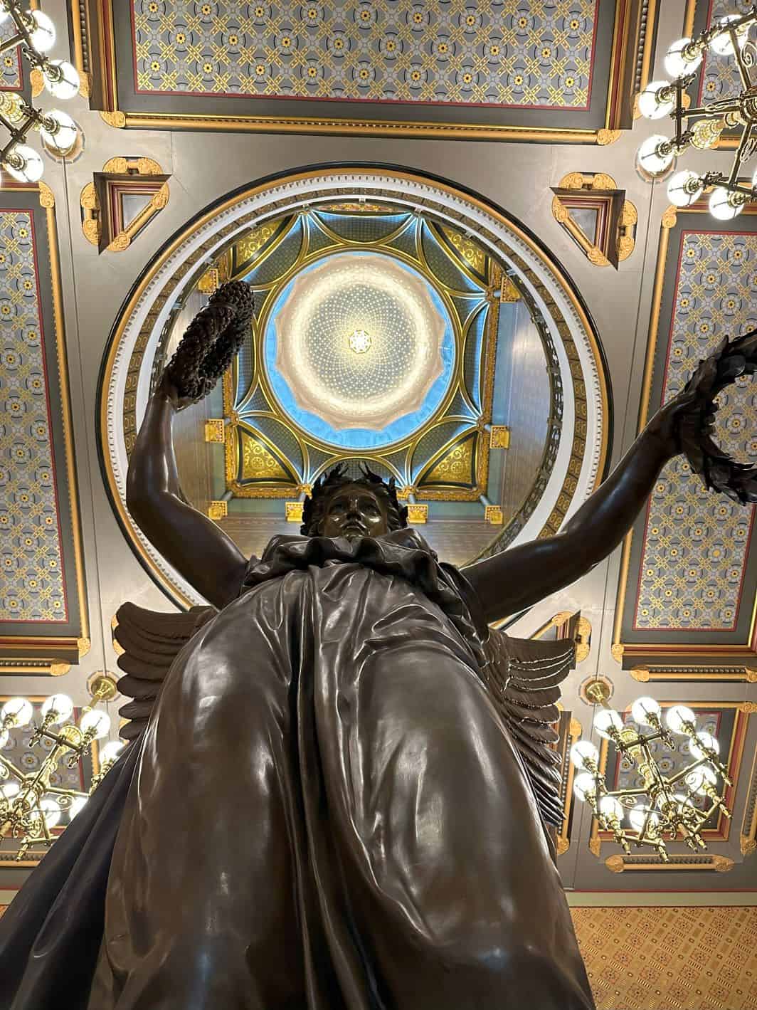 Looking up at the dome through the arms of the Genius of Connecticut replica. 